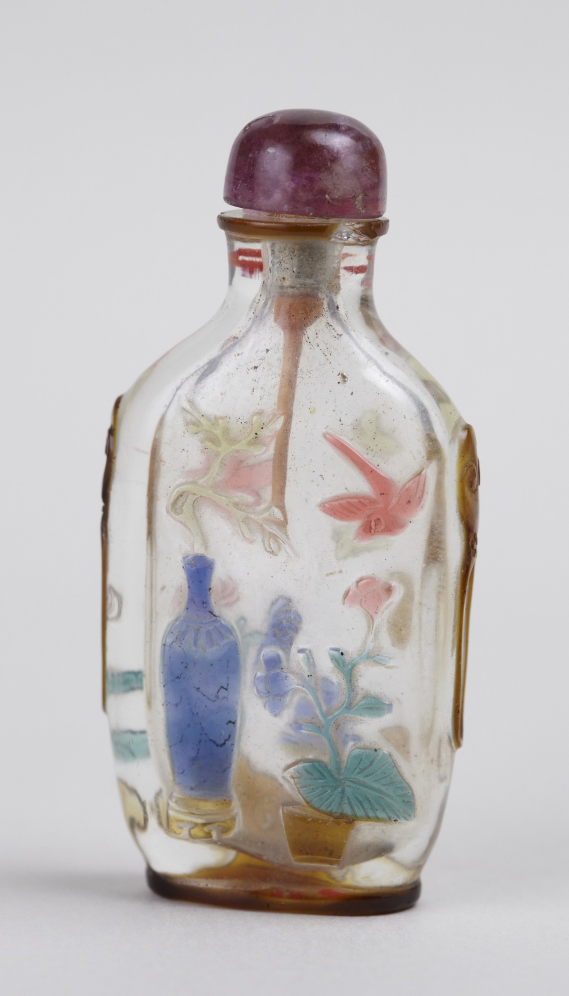 Clear glass snuff bottle with flowers and insects carved from the  multi-colored overlay (y1936-741.1)