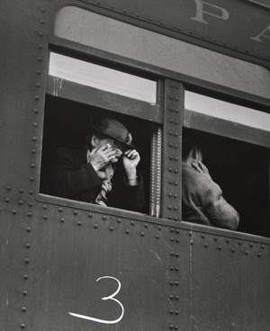 Photograph by Dorothea Lange titled Ten cars of evacuees of Japanese ancestry are now aboard and the doors are closed. Evacuees are bound for Merced Assembly Center [Temporary Detention Center], California, 1942, printed ca. 1955–65.