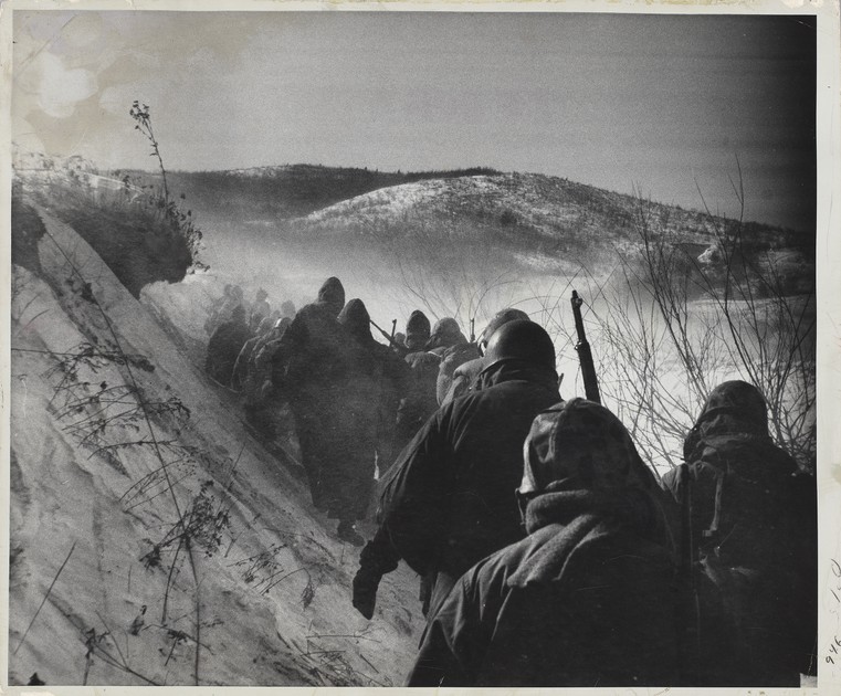 Marines marching down a canyon road they called 